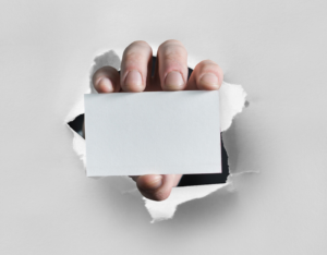 A man holding a blank white card