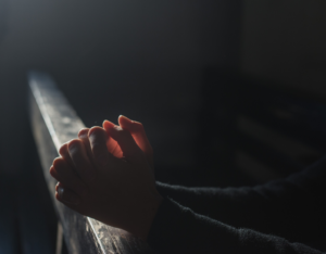 Person praying in church