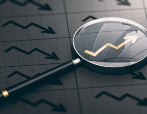 3D illustration of a magnifying glass over a golden positive chart symbol.